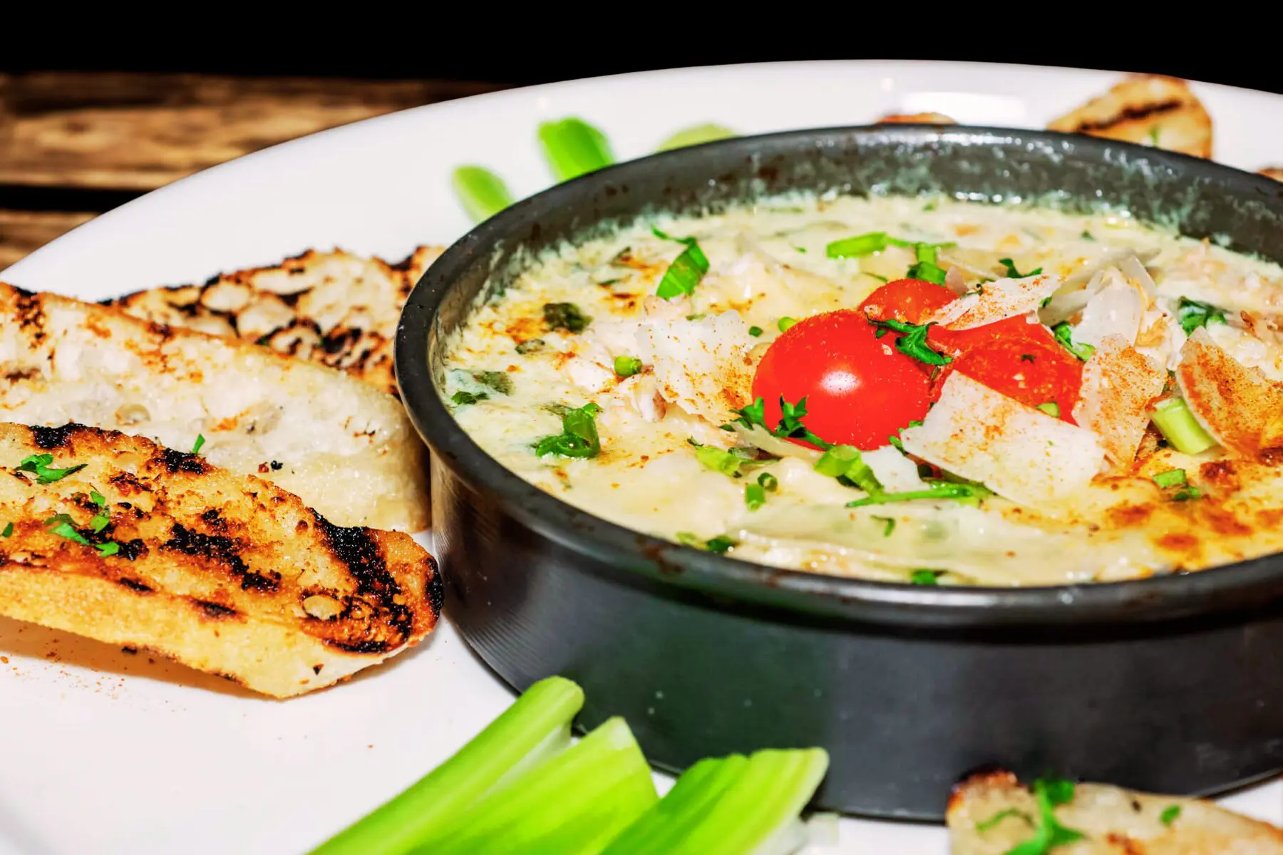 Cheesy dip with bread and vegetables.